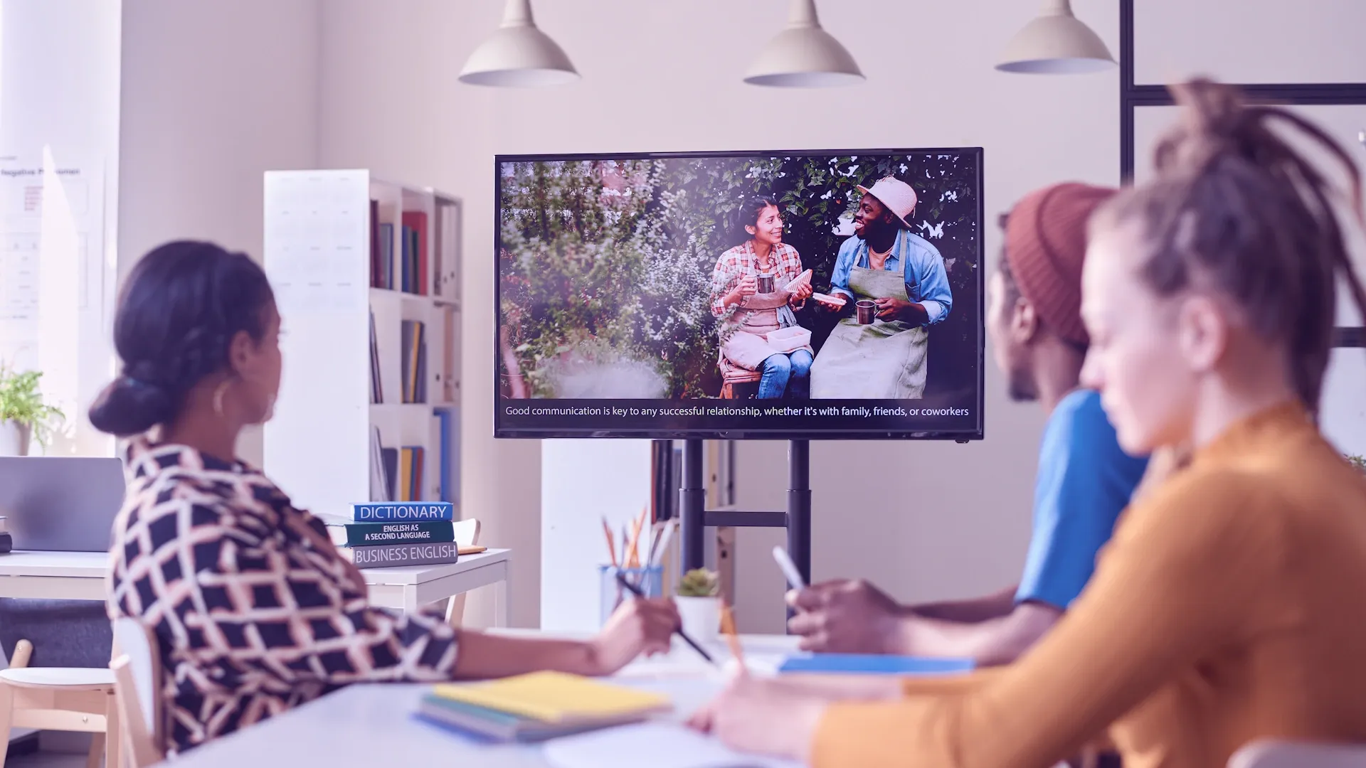 Employees are using an enterprise e-learning video to learn about their company.
